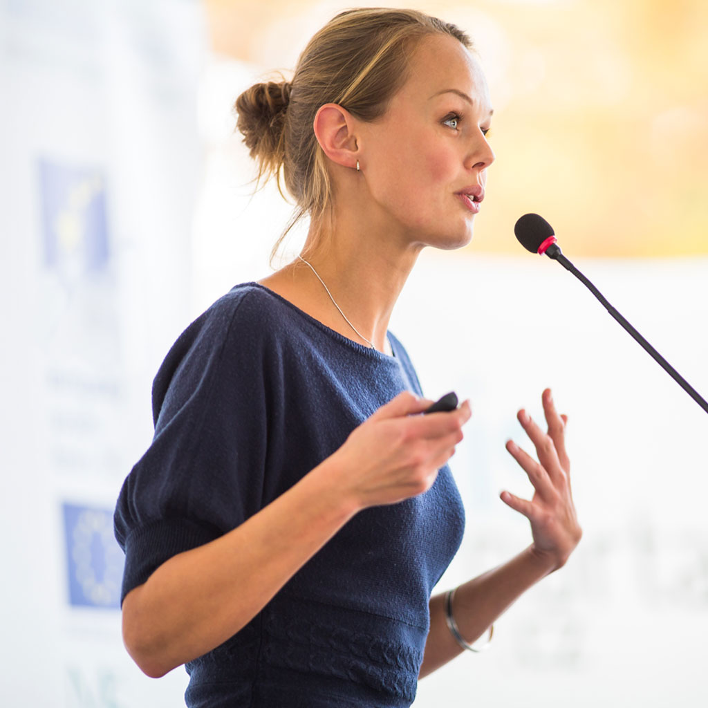 Speaker with a microphone giving a presentation